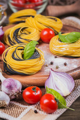 Wall Mural - Cherry tomatoes, uncooked spaghetti, red onion and herbs