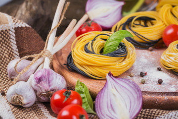 Wall Mural - Cherry tomatoes, uncooked spaghetti, red onion and herbs