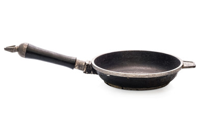 Old empty cast iron frying pan isolated on white background