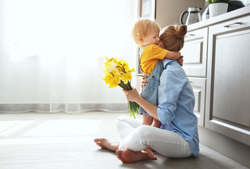 Wall Mural - happy mother's day! baby son gives flowersfor mother on holiday