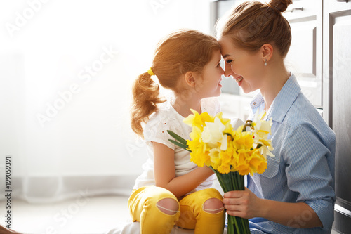 Fotografie, Obraz happy mother's day! child daughter gives mother a bouquet of flowers to narcis