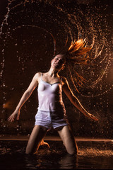 Wall Mural - Girl in white dress in water in a dark water in pool in studio and dark background