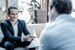 © Viacheslav Yakobchuk - Business project. Joyful nice happy businessmen smiling and looking at each other while having a business meeting