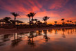 Beautiful romantic sunset over a sandy beach and palm trees. Egypt. Hurghada