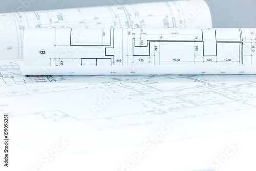 Fotografie, Obraz architectural project drawings and blueprints rolls on desk as construction back