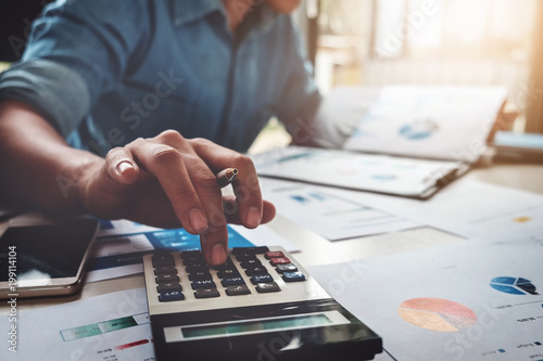 Fotomural Business accounting concept, Business man using calculator with computer laptop, budget and loan paper in office