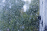 Fototapeta Łazienka - Drops of rain on a window. Abstract urban background.