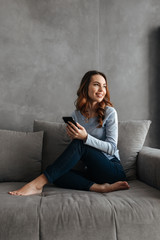 Canvas Print - Portrait of a pretty young woman using mobile phone