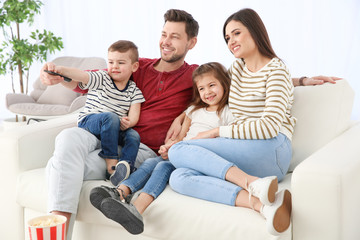 Canvas Print - Family watching TV on sofa at home