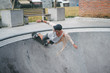 extreme young skater in pool of skatepark