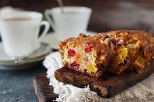 Traditional fruit cake pudding with dried fruits on wooden board