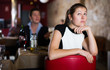 woman sitting apart in restaurant with drunk man