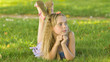 © Довидович Михаил - Beautiful young blonde girl lying on a field, green grass. Outdoors Enjoy Nature. Healthy Smiling Girl lying in Green Grass