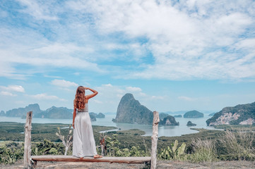 beautiful girl  staying on the top of hill with fantastic panoramic view on beautiful Thai bay