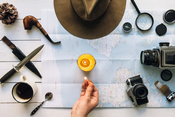 Wall Mural - adventure planning flat lay. travel vintage gear on white wooden table. man hand in frame lighting c