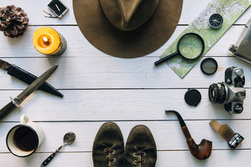 Wall Mural - adventure planning flat lay. travel vintage gear on white wooden table. including film camera, hat, 