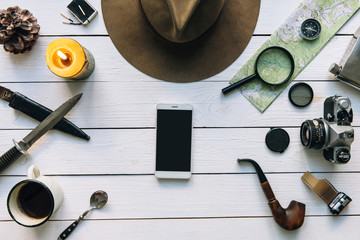 Wall Mural - adventure planning flat lay. travel vintage gear on white wooden table. including film camera, hat, 