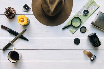 Wall Mural - adventure planning flat lay. travel vintage gear on white wooden table. including film camera, hat, 