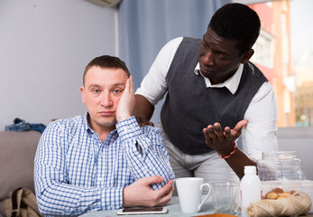 Wall Mural - African man calming friend after dispute