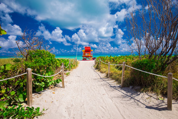 Miami Beach in South Beach with new lifeguard tower and coastline with colorful cloud and blue sky. Florida. USA. 