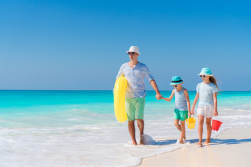 Father and little kids enjoying beach summer tropical vacation. Family playing on the beach