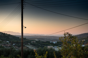 Wall Mural - Silhouette of agricultural field and power line, Crete, Greece