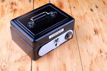 Cash box on the wooden table