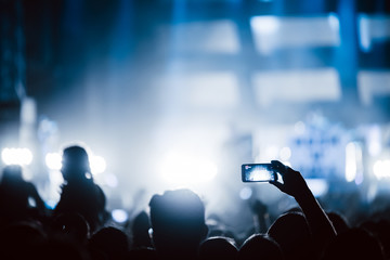 Cheering crowd at concert enjoying music performance