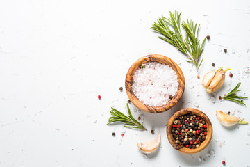 Spices and herbs over white stone table top view. 