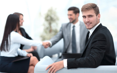 Canvas Print - successful business man at the office on the background of business team