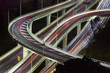 Aerial view of modern urban traffic road at night. Cityscape overpass with light trails. Brisbane Riverside Expressway, Australia.