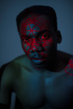 Portrait Of Man With Abstract Red Light On Face