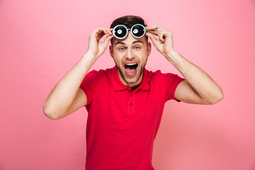 Wall Mural - Portrait of a happy young man in sunglasses