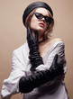 © monchak - Fashion portrait of beautiful young woman in black leather beret cap, white shirt and cat eye retro sunglasses