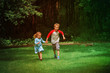 © nadezhda1906 - happy little girl and boy run play in summer nature