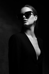 sexy elegant black and white portrait of young beautiful woman in black deep v neck jacket and dark 
