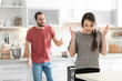 © New Africa - Young couple having argument in kitchen