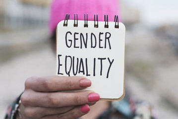 Wall Mural - woman with a pink hat and the text gender equality