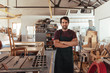 © mavoimages - Craftsman standing by a bench saw in his woodworking shop