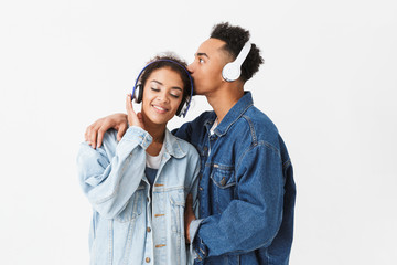 Wall Mural - Happy lovely african couple in denim shirts posing together