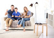 © Africa Studio - Happy family playing video games at home