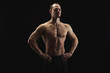 © Prostock-studio - Strong athletic man showes naked muscular body