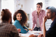 © jackfrog - meeting at the company. A young woman leads a multi-ethnic group