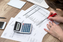 Woman Counting Her Budget, Hands With Calculator