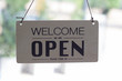 A sign hanging open Coffee shop door,Open sign blur background,Label word open