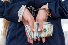 Arrested Woman With Hands And Money Behind Back