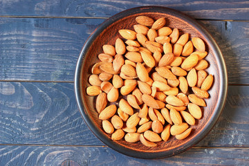 Wall Mural - Almond in a plate copy space