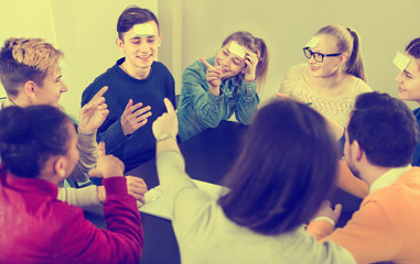 Wall Mural - Fellow students playing guess-who game