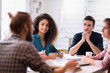 © jackfrog - At office. A young man leads a multiethnic working group