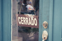 Cerrado (closed) Sign On Door - Spanish Word "cerrado" (closed) On Shop Entrance -